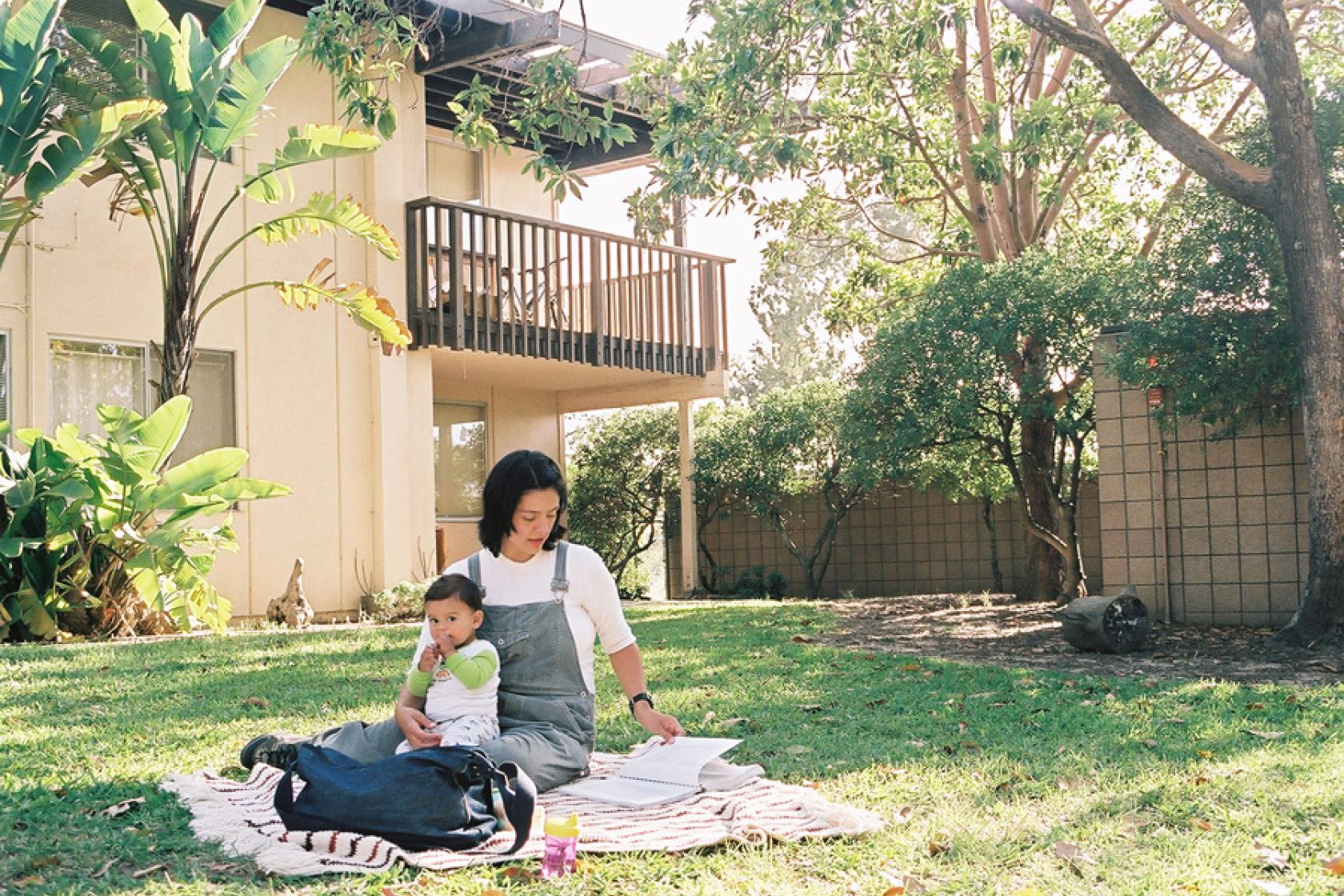 family sitting outside on lawn