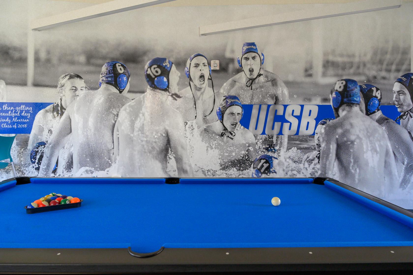 pool table in the recreation room with wall graphics