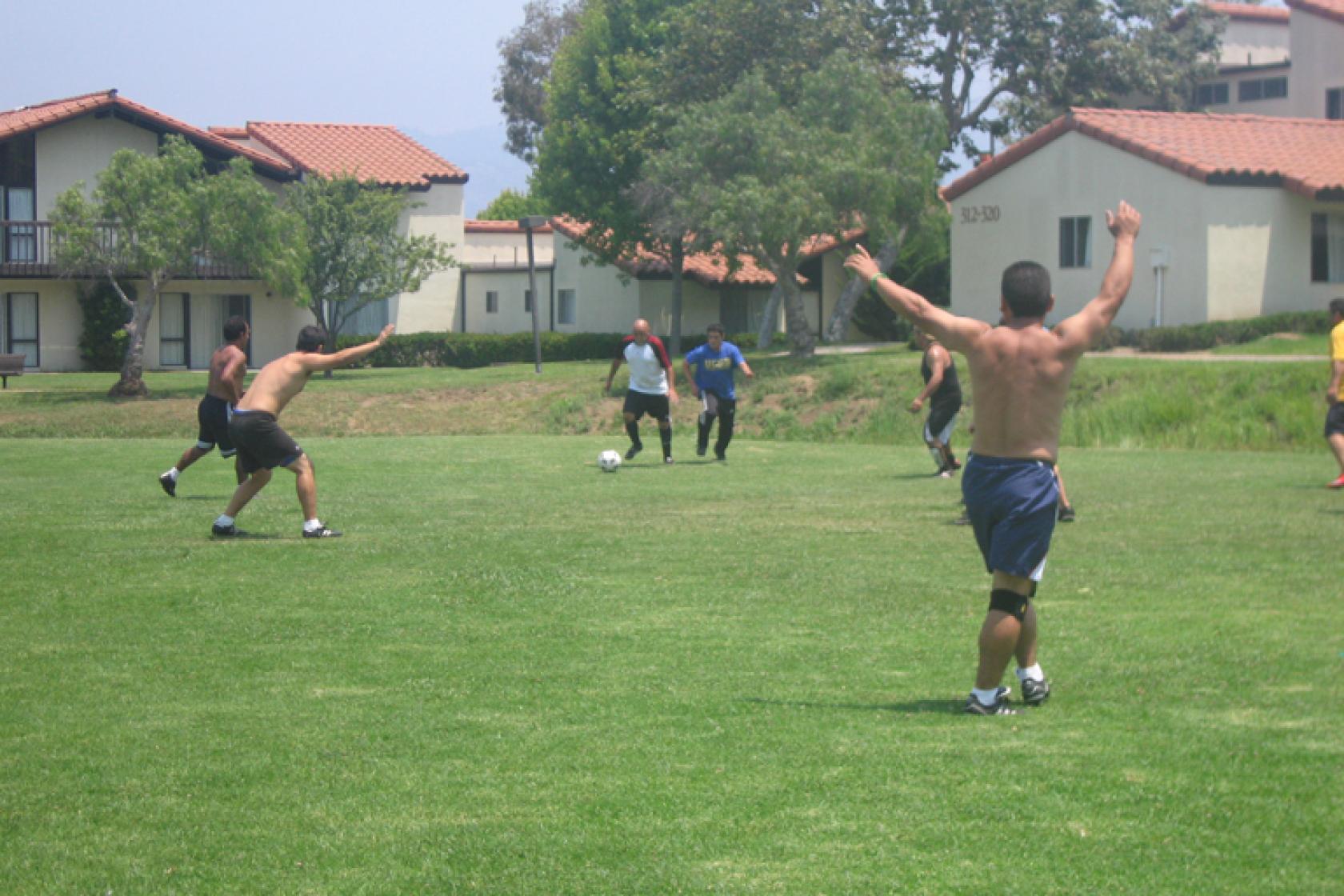 students playing soccer on the lawn