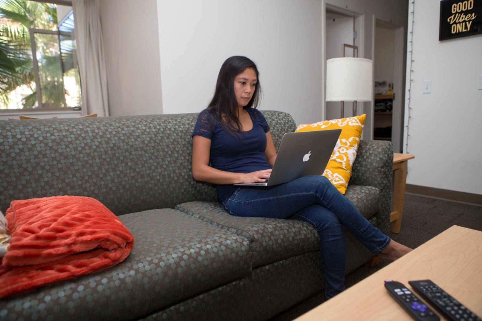student sitting on San Clemente couch 